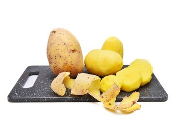 Whole and cutting fresh potato on the cut border isolated on white background
