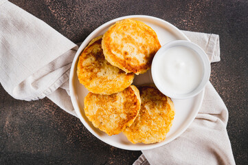 Close up of crispy mashed potato pancakes and gravy on a plate on the table top view