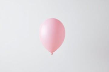 single bright minimalistic pink balloon floats conspicuously in middle of vast white background