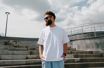 White T-shirt on a bearded hipster in sunglasses — urban mockup for brands