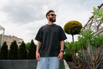 Bearded hipster in black t-shirt and sunglasses — urban mockup for brands