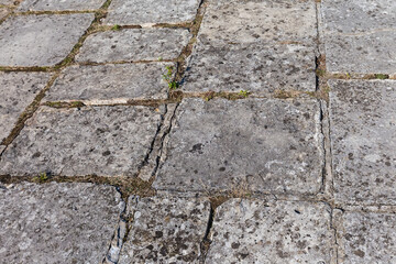 Surface of court of ancient castle lined with stone slabs