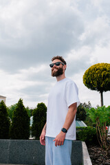 White T-shirt on a bearded hipster in sunglasses — urban mockup for brands