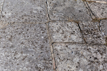 Surface of court of ancient castle lined with stone slabs