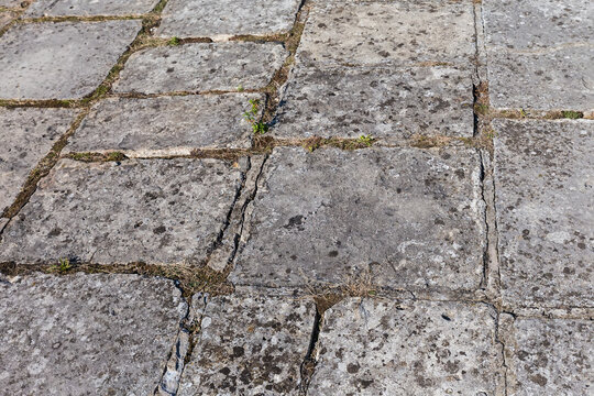 Surface of court of ancient castle lined with stone slabs