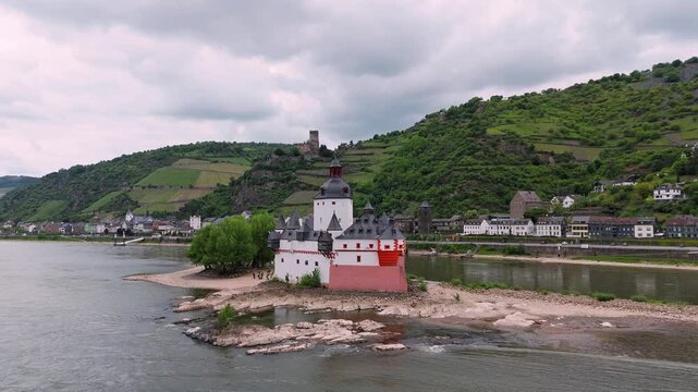 Pfalzgrafenstein Castle, a 14th-century toll castle, stands on Falkenau island in the Rhine River near Kaub, Germany. Part of the UNESCO Upper Middle Rhine Valley, accessible by ferry.