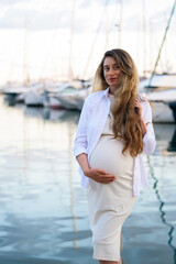 Pregnant woman posing at the port of Golfe Juan, France