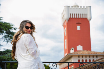 Woman posing at Chateau de Cremat with red building