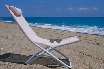 Sea, sun and chair with sea view. Sunglasses, sea, vacation. Summer mood.