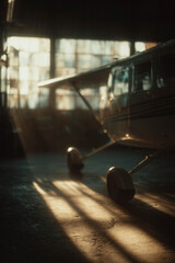 Light aircraft inside the hangar with the sun trapped inside the hangar
