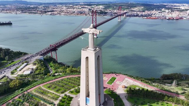King Christ At Almada District Of Lisbon Portugal. Aerial View Of A High-Rise Buildings And Traffic Showcasing Urban Life. Town Clouds Sky Backgrounds Urban. Backgrounds Downtown Panorama.