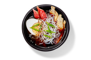 Steaming chicken and shirataki noodle soup with egg and sesame seeds