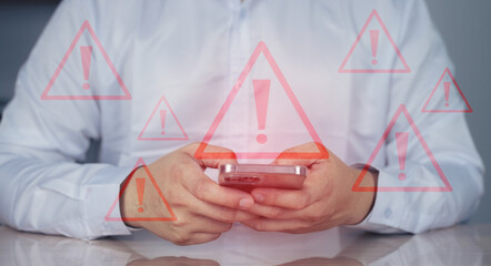 Person holding a smartphone with multiple digital red warning, Emergency warning alert alarm on Smartphone, Data network protection, Virus alarm.