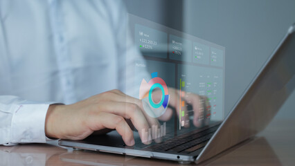 Businessman Typing on Laptop with Data Analytics Visualizati on a laptop with digital graphs and charts overlaid, illustrating data analysis, business intelligence, and online performance monitoring.