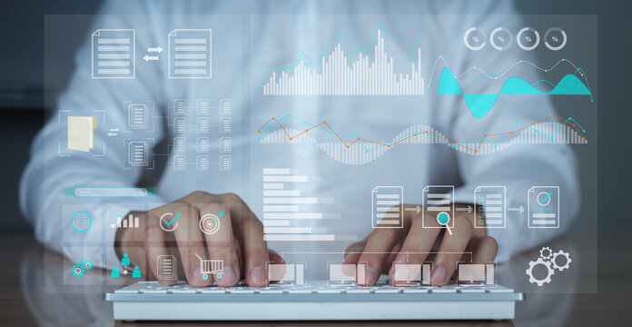 Close-up of hands typing on a white keyboard with overlay of digital business interface including graphs, analytics, and dashboard icons. Represents modern office, business intelligence, big data.