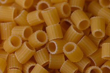 Full frame of dry Ditaloni Rigati pasta used as a culinary texture background. Perfect for food...