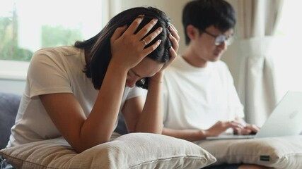 Slow motion scene technology and relationship problem, asian husband concentrate on working, social media, video game and ignore wife in living room, woman is annoyed bored about their communication  - Powered by Adobe