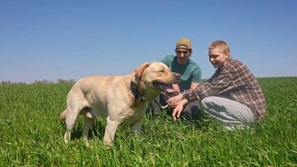 People Enjoying a Day Outdoors with Their Happy Dog