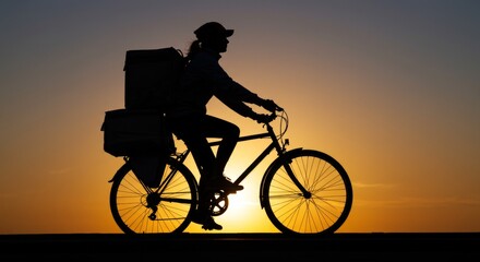 Fototapeta premium Silhouette of a food delivery cyclist at sunset, Fast delivery concept