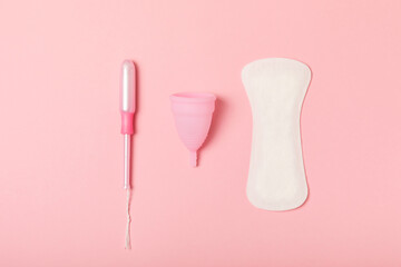 Menstrual cup on a bright background. Sanitary napkins, tampons and menstrual cup.Concept of critical days, menstruation.feminine hygiene product. Women health concept.Premenstrual syndrome.Copy space
