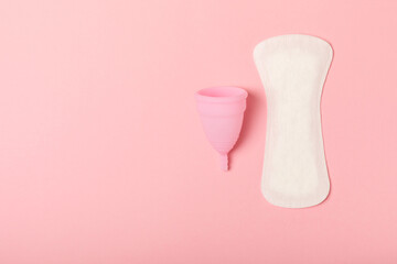 Menstrual cup on a bright background. Sanitary napkins, tampons and menstrual cup.Concept of critical days, menstruation.feminine hygiene product. Women health concept.Premenstrual syndrome.Copy space