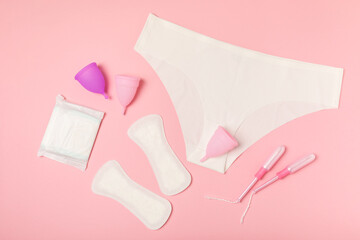 Menstrual cup on a bright background. Sanitary napkins, tampons and menstrual cup.Concept of...