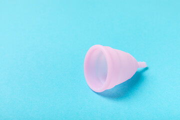 Menstrual cup on a bright background. Sanitary napkins, tampons and menstrual cup.Concept of...