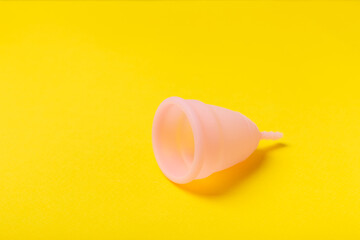 Menstrual cup on a bright background. Sanitary napkins, tampons and menstrual cup.Concept of critical days, menstruation.feminine hygiene product. Women health concept.Premenstrual syndrome.Copy space
