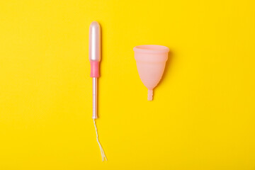 Menstrual cup on a bright background. Sanitary napkins, tampons and menstrual cup.Concept of critical days, menstruation.feminine hygiene product. Women health concept.Premenstrual syndrome.Copy space