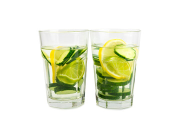 Cucumber water with lemon, lime and mint isolated on white background. Water infused with sliced ​​cucumber in a drinking glass. Tonic refreshing drink. Cucumber lemonade.Summer natural cooling drink