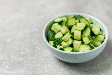 Cucumber on wooden background. Slice of cucumber on background. Fresh organic green cucumbers gherkin. Vegan. Salad ingredient. Farm vegetables. Cut vegetables with knife. Space for text. Copy space