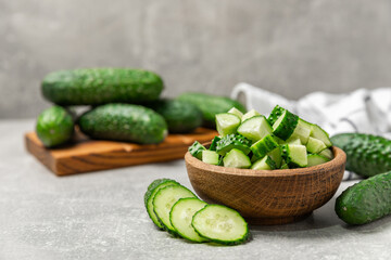 Cucumber on wooden background. Slice of cucumber on background. Fresh organic green cucumbers gherkin. Vegan. Salad ingredient. Farm vegetables. Cut vegetables with knife. Space for text. Copy space