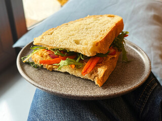 Vegetarian Sandwich with Greens, Carrots, Radishes, and Hummus. Plant-Based Food Concept. Handmade Mobile Photo, Selective Focus, Not AI.