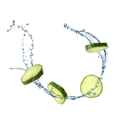 Cucumber slices and splashing water in air on white background