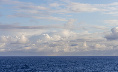 Serene Ocean View With Blue Waters and a Cloud-Filled Sky