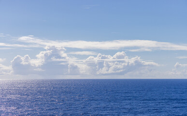 Tranquil Ocean View With Clouds Under A Clear Blue Sky