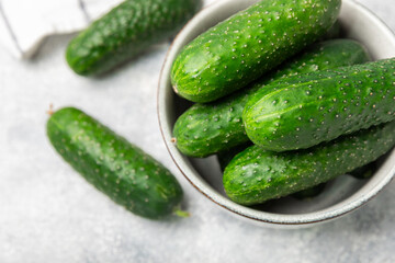 Cucumber on wooden background. Slice of cucumber on background. Fresh organic green cucumbers gherkin. Vegan. Salad ingredient. Farm vegetables. Cut vegetables with knife. Space for text. Copy space