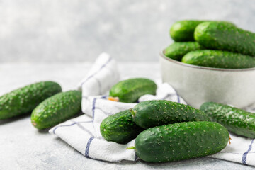 Cucumber on wooden background. Slice of cucumber on background. Fresh organic green cucumbers gherkin. Vegan. Salad ingredient. Farm vegetables. Cut vegetables with knife. Space for text. Copy space