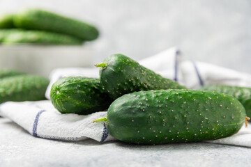 Cucumber on wooden background. Slice of cucumber on background. Fresh organic green cucumbers gherkin. Vegan. Salad ingredient. Farm vegetables. Cut vegetables with knife. Space for text. Copy space