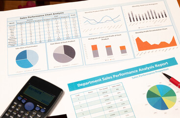 Financial reports with charts and calculator on office desk