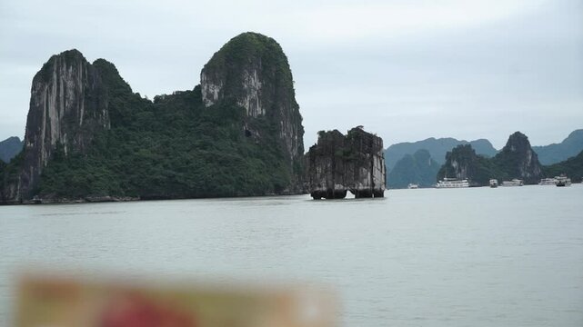 A man compares the image on a 200,000 dong banknote to a cliff in HaLong Bay