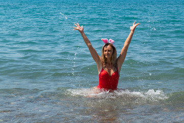 Seaside Christmas Splash: Girl in Red Swimsuit with Santa Hat