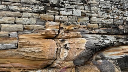 Natural sandstone texture with intricate layers, swirls, and patterns in warm earth tones. Perfect for backgrounds, design projects, geology, and nature-themed content.