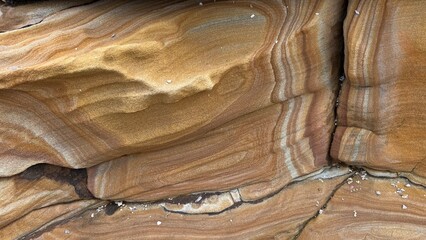 Natural sandstone texture with intricate layers, swirls, and patterns in warm earth tones. Perfect...