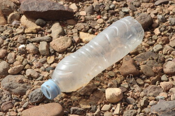 A single empty plastic bottle lying on the ground, Environmental pollution