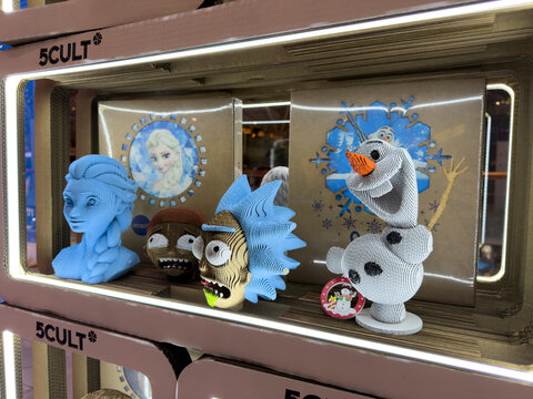 Moscow, Russia, April 25, 2025: Display of cartoon character busts made of layered cardboard in 5CULT store, featuring designs from Frozen and Rick and Morty as part of collectible pop culture art
