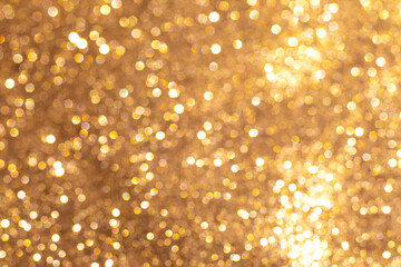 Golden glitter background with bokeh lights creating a sparkling festive ambiance