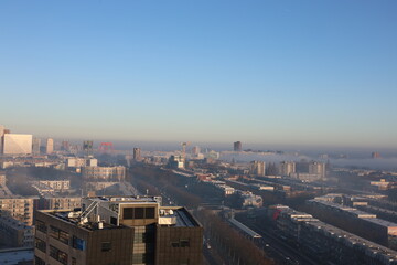 A misty landscape photo with the Nieuwe Maas River in Rotterdam, the Netherlands, in the background.