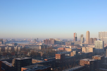 A misty landscape photo with the Nieuwe Maas River in Rotterdam, the Netherlands, in the background.