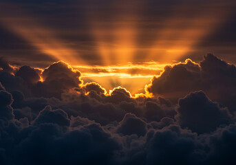 Dramatic sunset with golden light shining through clouds creating beautiful crepuscular rays in sky. The sun's rays pierce the cloud cover illuminating the scene with a warm ethereal glow